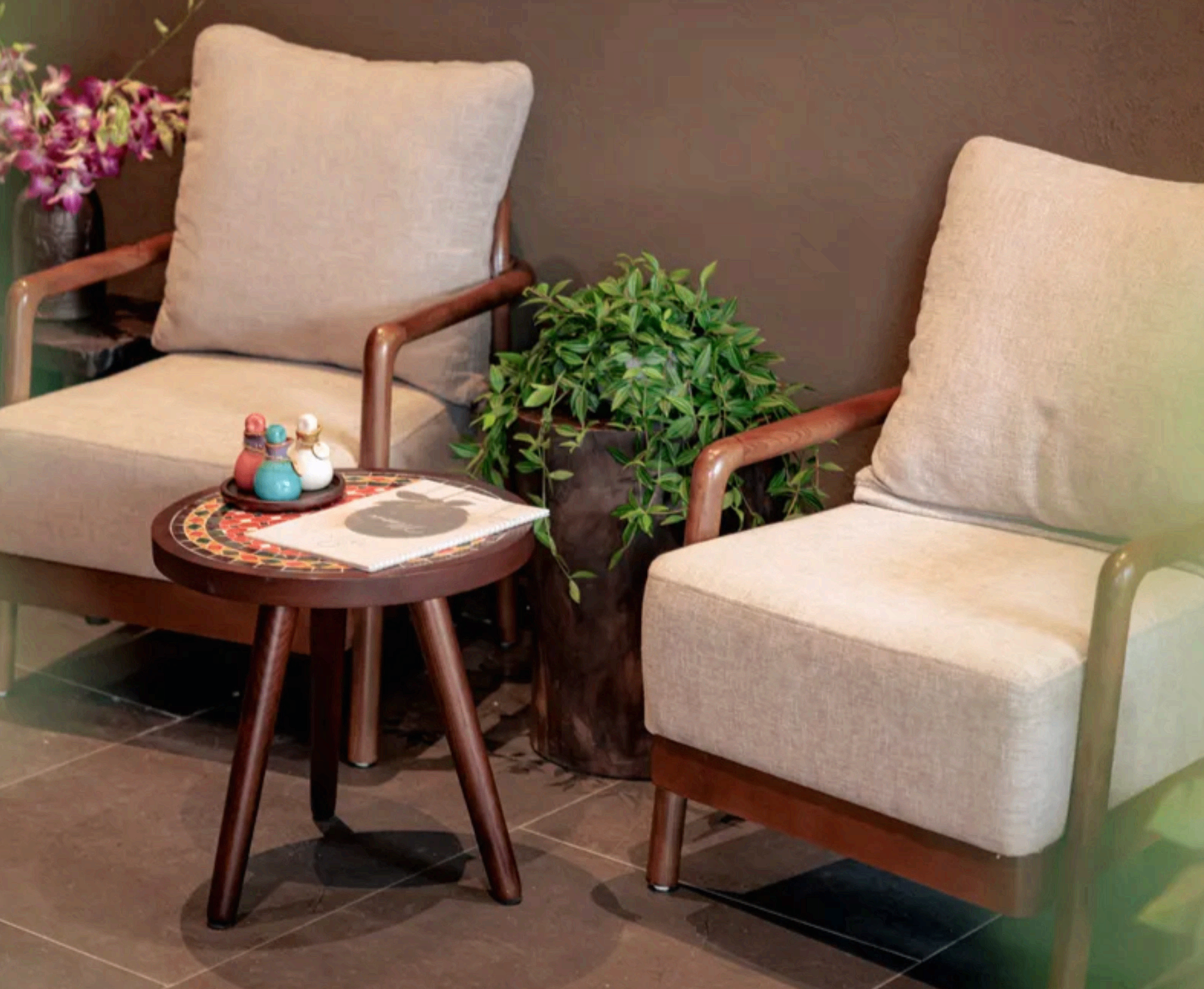 Paz Spa Bali lounge chairs beside a side table and greenery